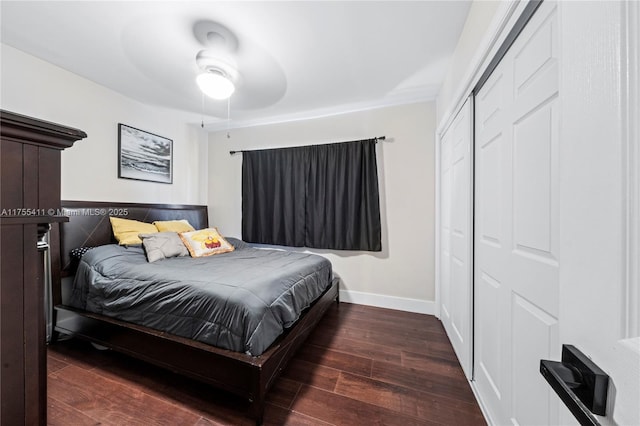 bedroom featuring a ceiling fan, a closet, baseboards, and wood finished floors