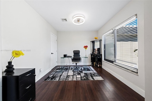 office area with baseboards, visible vents, and wood finished floors