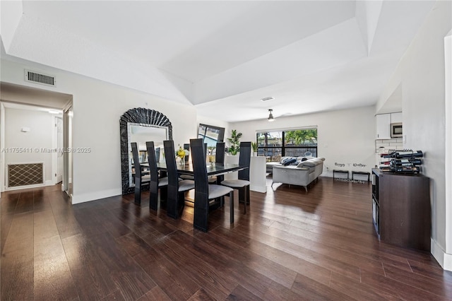 dining room with baseboards, visible vents, and dark wood-type flooring