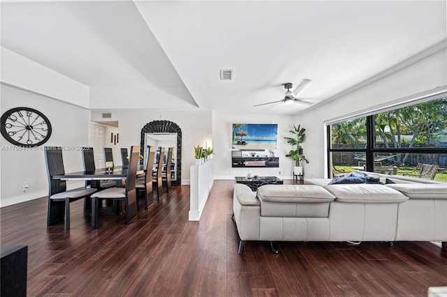 living room with ceiling fan, visible vents, and wood finished floors