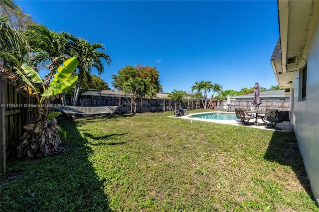 view of yard featuring a patio area, a fenced backyard, and a fenced in pool