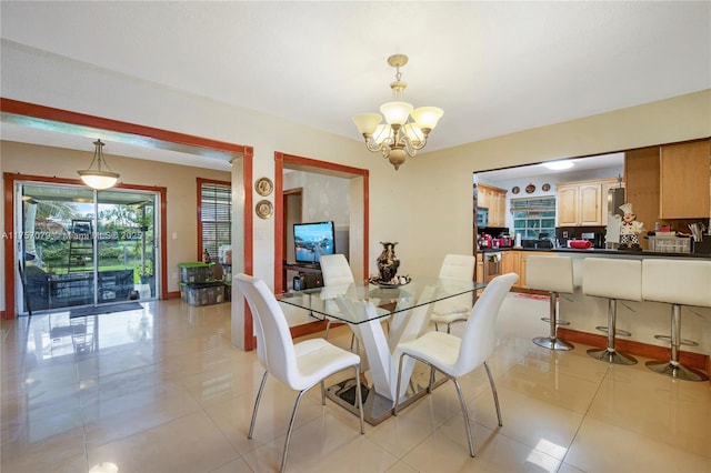 dining room with a notable chandelier and light tile patterned floors