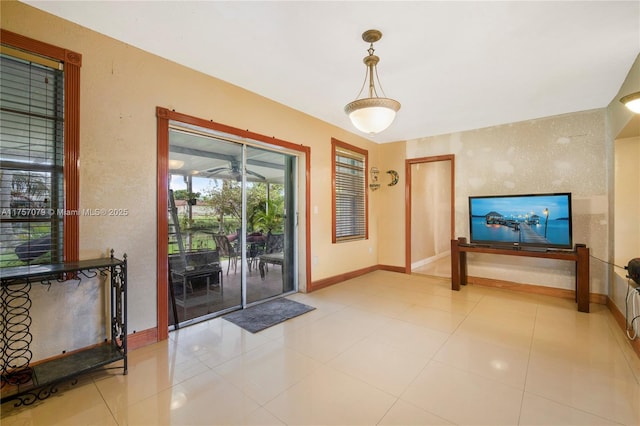 living room with light tile patterned floors and baseboards