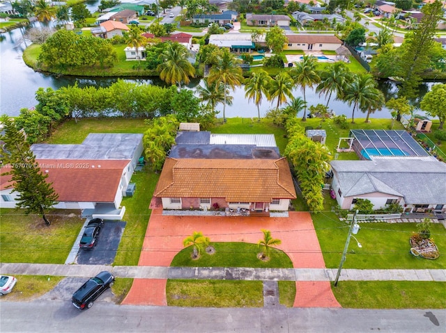 drone / aerial view featuring a water view and a residential view