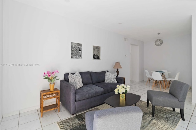 living area featuring light tile patterned flooring and visible vents