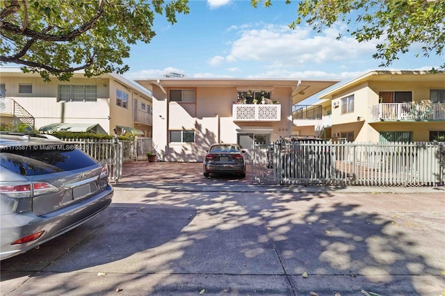 view of front of property featuring fence and stucco siding