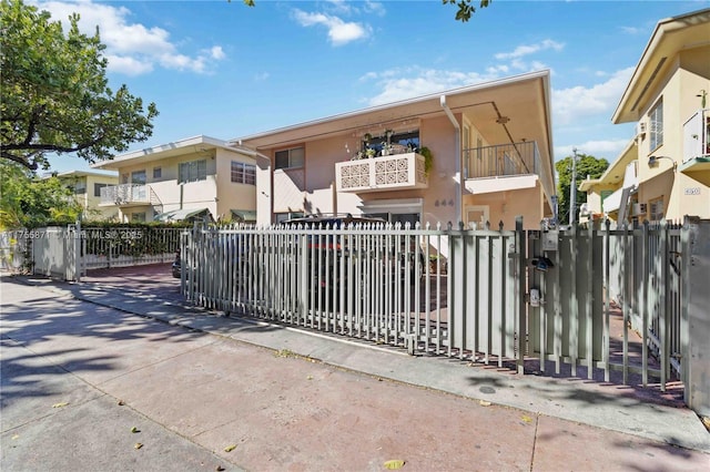 view of gate with a fenced front yard and a residential view