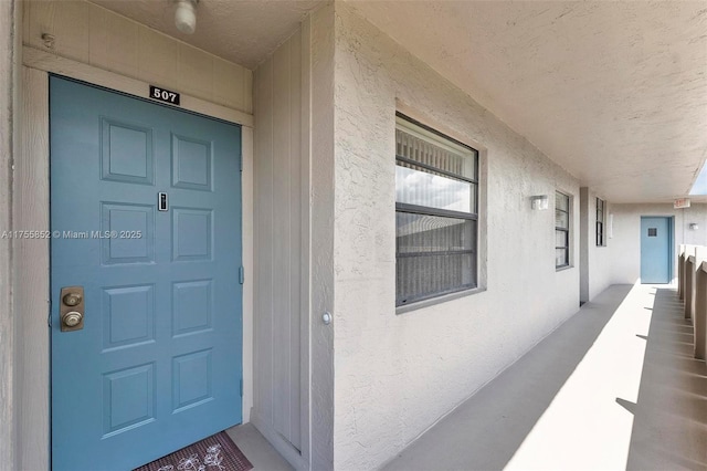 doorway to property with stucco siding