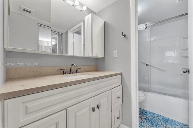 full bathroom featuring toilet, shower / bath combination with glass door, visible vents, and vanity