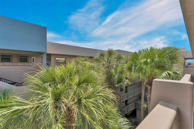 exterior space with a balcony and stucco siding