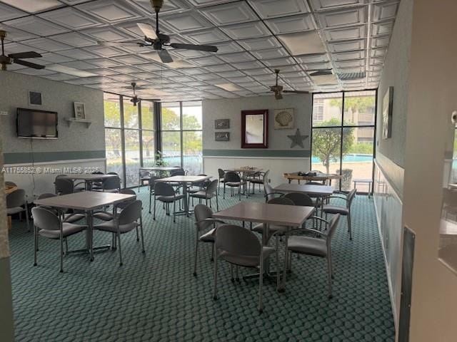 dining area with carpet floors, an ornate ceiling, and ceiling fan