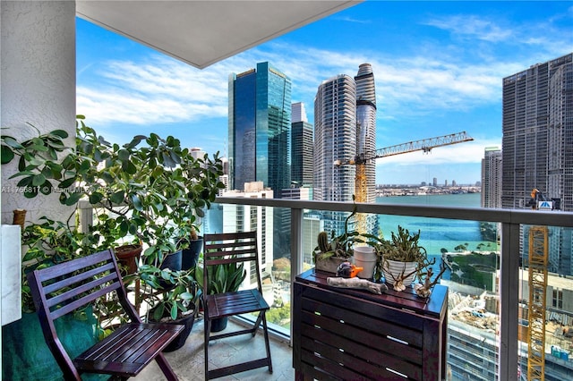 balcony featuring a water view and a view of city