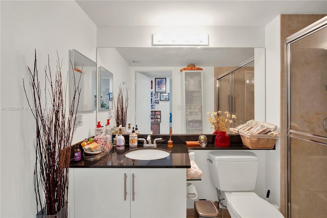 full bathroom with visible vents, a stall shower, vanity, and toilet