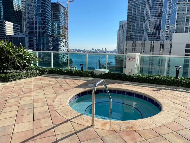 view of pool featuring a view of city and a community hot tub