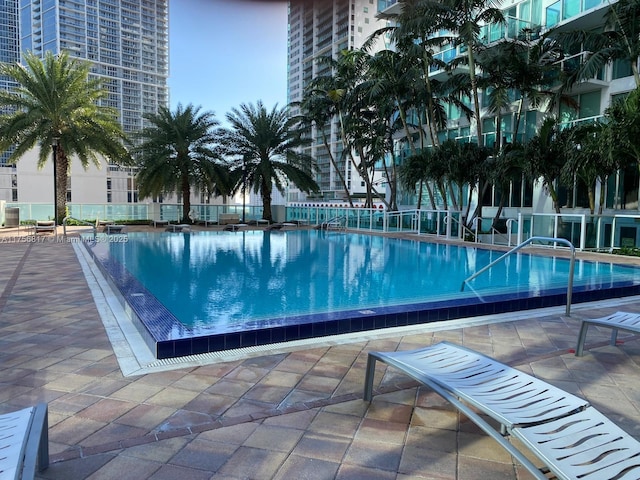 pool featuring fence and a patio