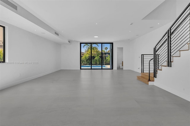 unfurnished living room featuring recessed lighting, visible vents, baseboards, and stairs