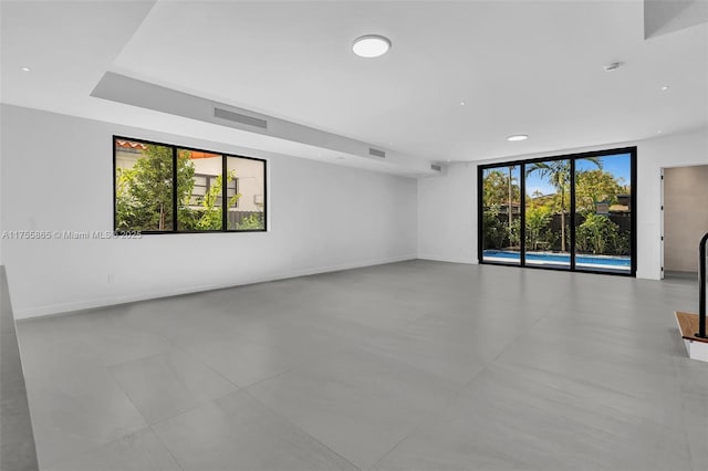 empty room with plenty of natural light, visible vents, and baseboards