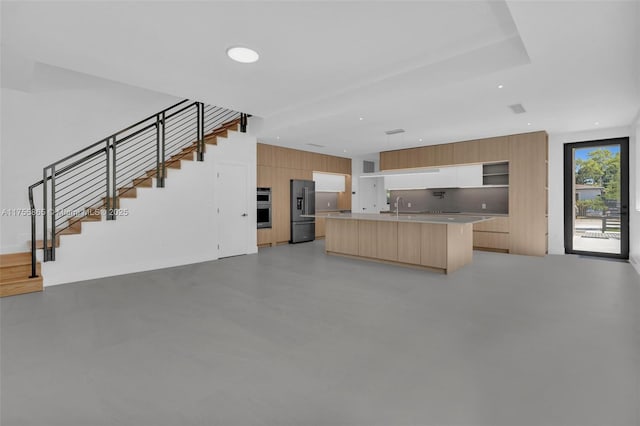 kitchen featuring modern cabinets, finished concrete floors, stainless steel appliances, light countertops, and a sink