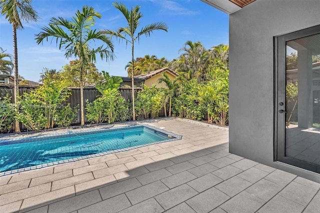 view of swimming pool featuring a fenced backyard, a fenced in pool, and a patio