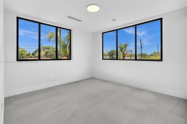 unfurnished room featuring visible vents and baseboards