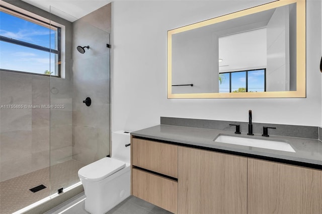 bathroom featuring a stall shower, vanity, and toilet