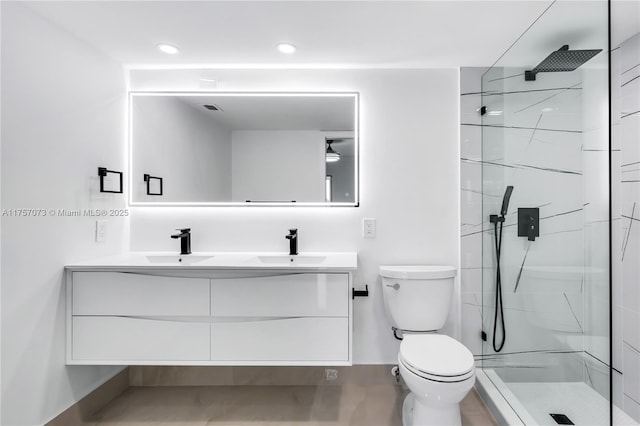 full bath with double vanity, a sink, toilet, and a walk in shower