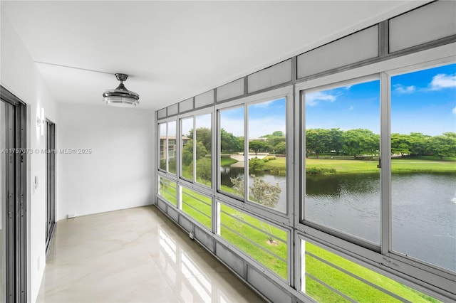 unfurnished sunroom featuring a water view