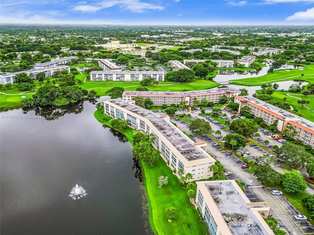 birds eye view of property featuring a water view and view of golf course