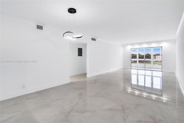 empty room featuring marble finish floor, visible vents, and baseboards