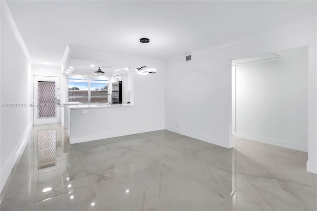 unfurnished living room featuring baseboards and visible vents