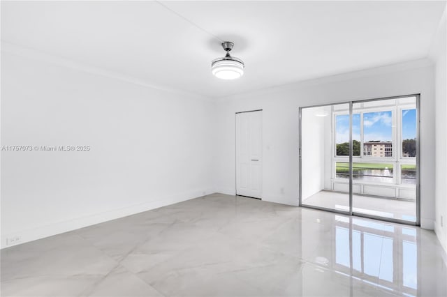 spare room featuring marble finish floor, baseboards, and ornamental molding