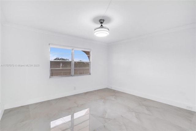 unfurnished room featuring crown molding and baseboards