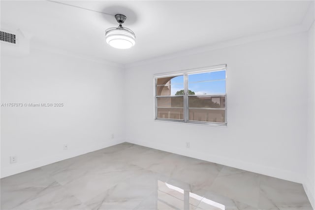 empty room with ornamental molding, visible vents, and baseboards