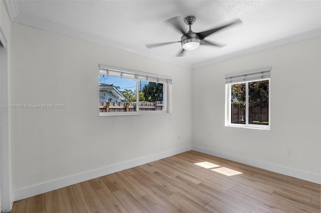 unfurnished room featuring ornamental molding, plenty of natural light, and wood finished floors