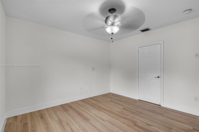 unfurnished room featuring baseboards, light wood-type flooring, visible vents, and a ceiling fan