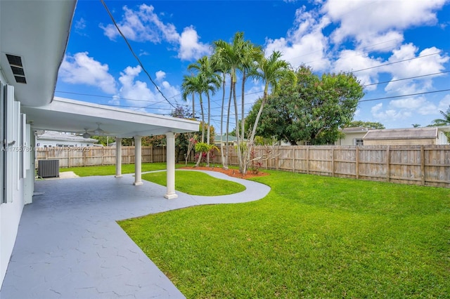 view of yard with a fenced backyard, a patio area, and cooling unit