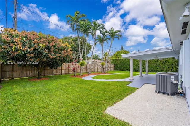 view of yard with ceiling fan, central AC, a patio area, and a fenced backyard