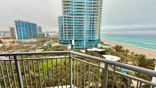 balcony featuring a water view, a view of the beach, and a city view