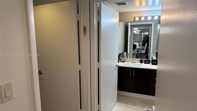 bathroom with tile patterned flooring, visible vents, and vanity