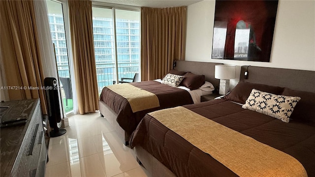 bedroom with light tile patterned floors, access to outside, and expansive windows