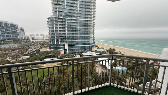 balcony with a water view, a beach view, and a city view