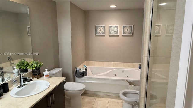 full bathroom with a whirlpool tub, vanity, toilet, and tile patterned floors