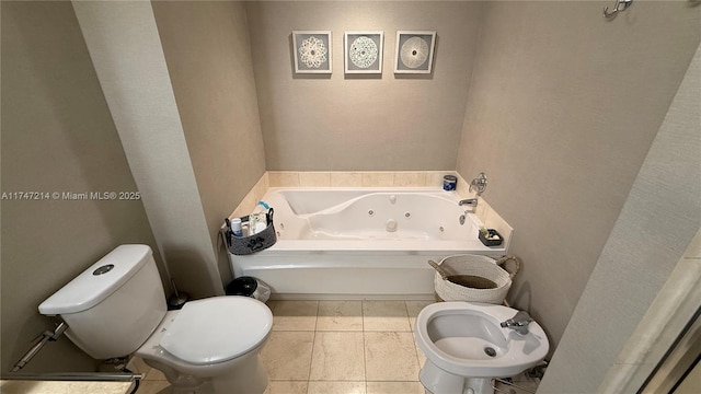 bathroom featuring a tub with jets, toilet, and tile patterned floors