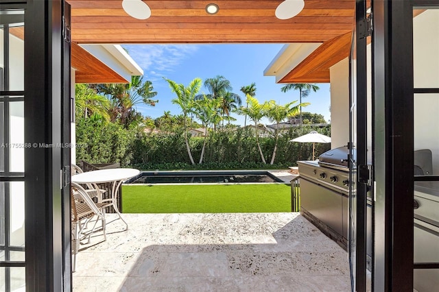 exterior space featuring exterior kitchen and a balcony