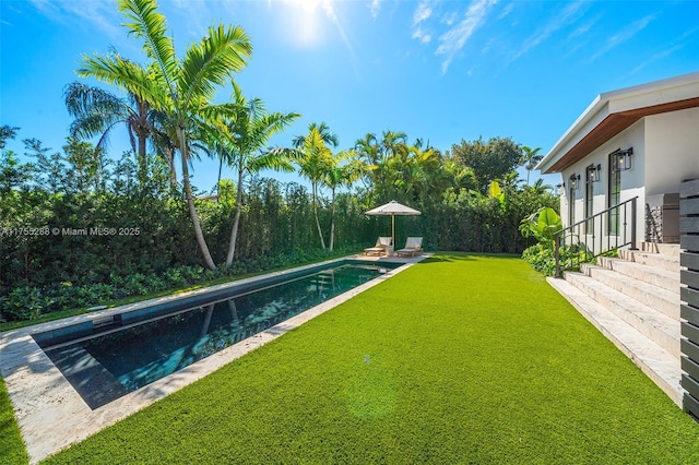 view of swimming pool with a patio area, a fenced in pool, and a yard