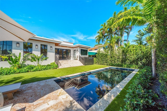 outdoor pool with a yard