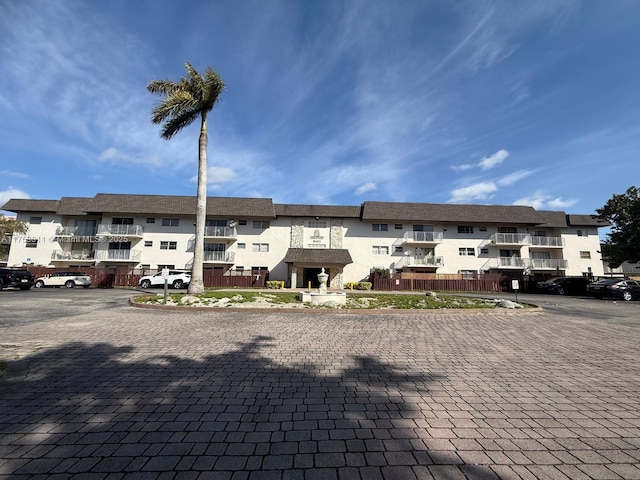 view of property featuring a residential view and uncovered parking