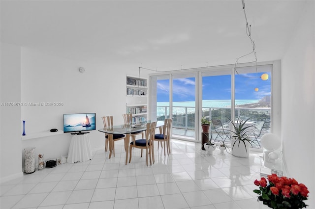 dining room with expansive windows and light tile patterned floors