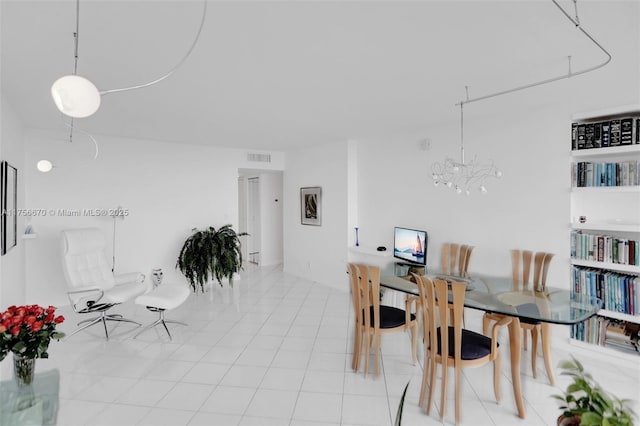 tiled dining room with a chandelier and visible vents