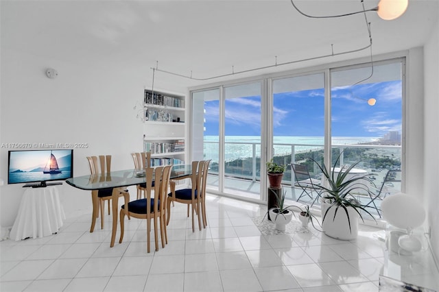 dining space featuring expansive windows and light tile patterned floors